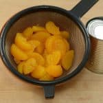 canned oranges put in a strainer