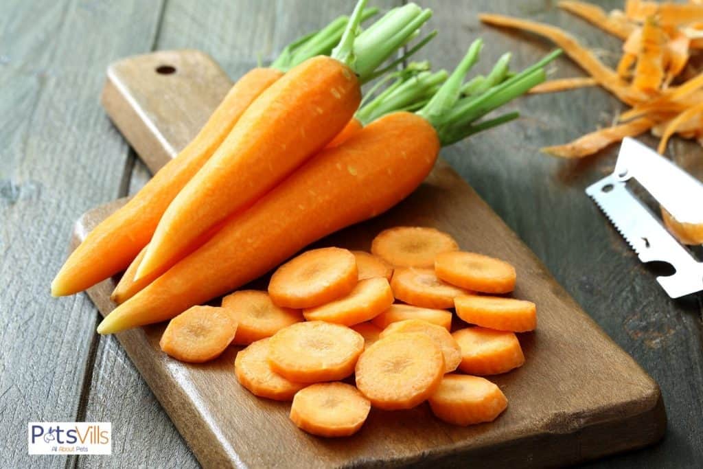 chopped and peeled carrots on a wooden chopping board