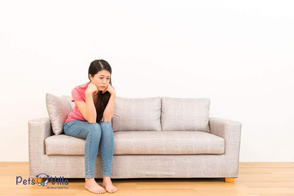 person sitting on a couch worrying