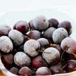 a bowl of frozen grapes